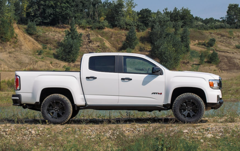 white 2021 gmc canyon angle view parked on a terrain