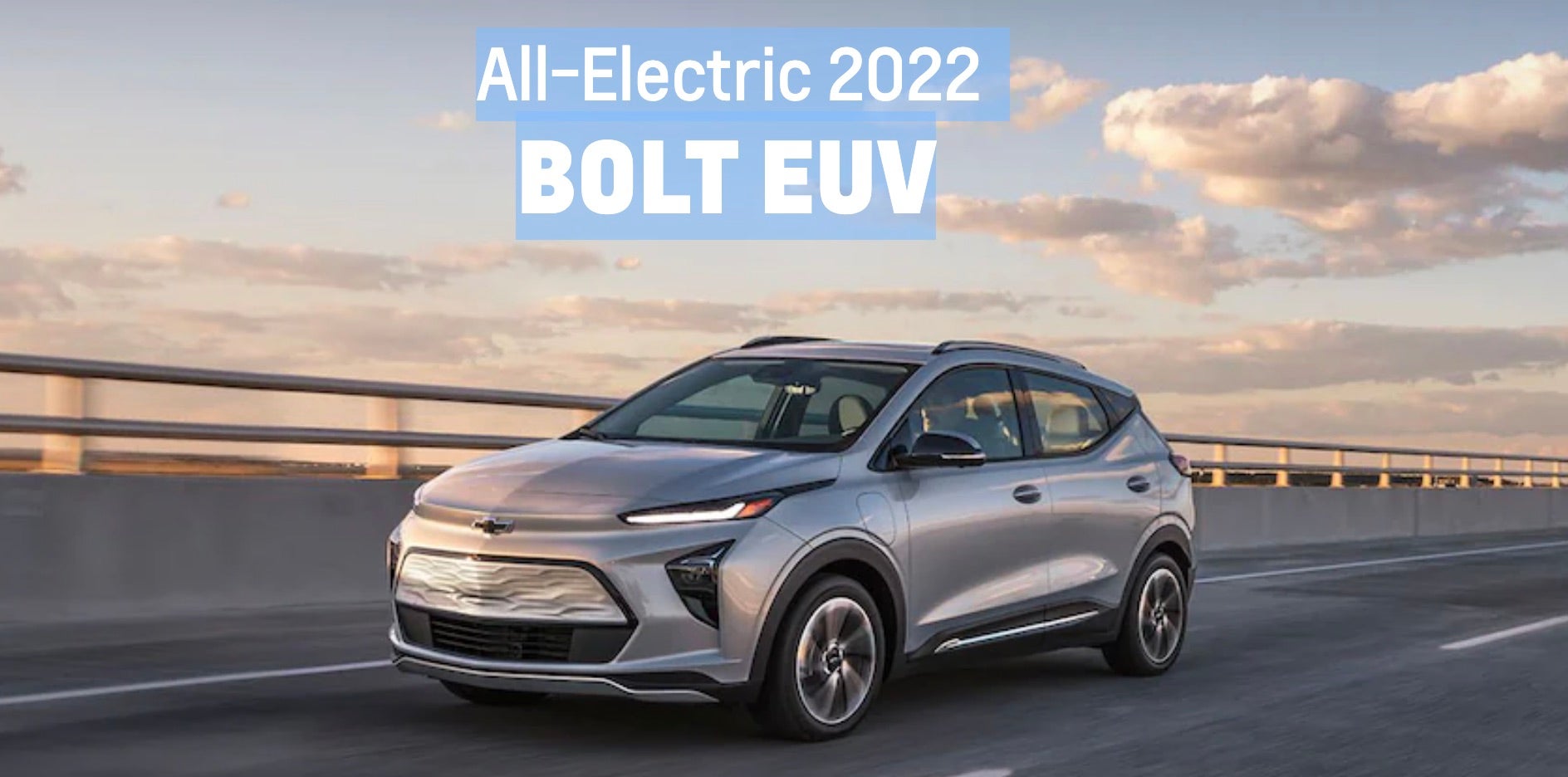 2022 Chevrolet Bolt EUV driving on the interstate with the sun setting in the background.