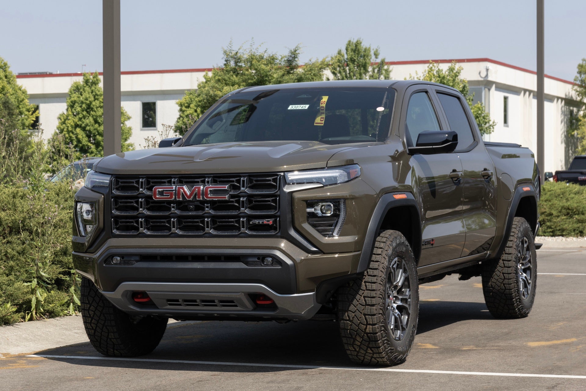 GMC Canyon AT4 pickup display at a dealership. GMC offers the Canyon in Elevation Standard, Elevation, and Denali models.