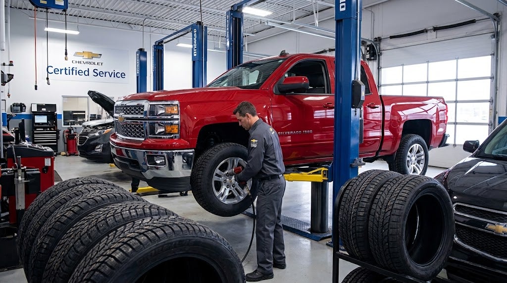 Chevrolet technician installing winter tires on a Chevy truck.