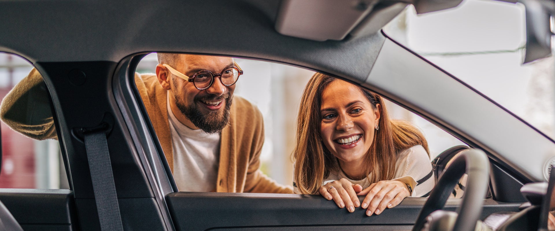 Couple examining car interior