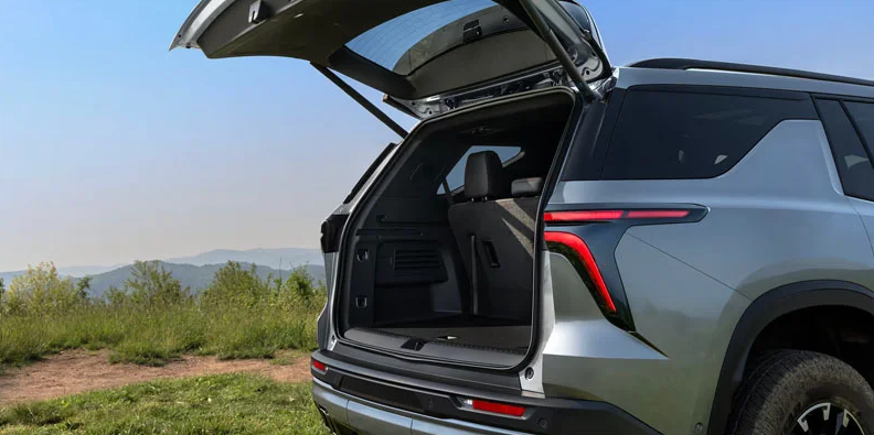 A photo of the back of a green 2026 Chevy Traverse.