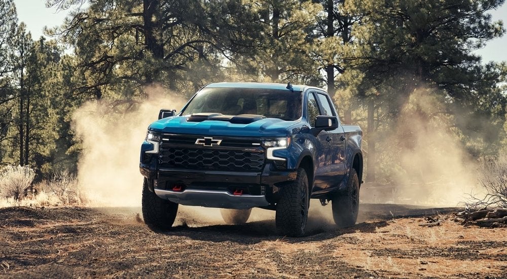 Blue 2025 Chevy Silverado 1500 ZR2 driving off-road