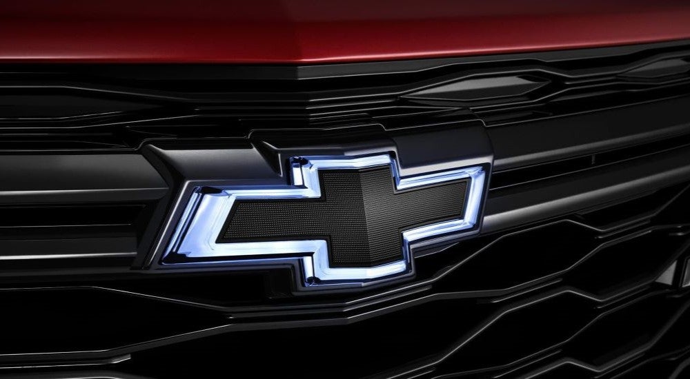 Chevy logo on the grille of a red 2024 Chevy Equinox RS