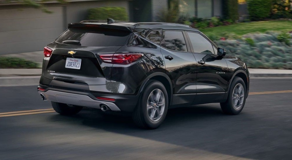 Black 2024 Chevy Blazer driving on a suburban street