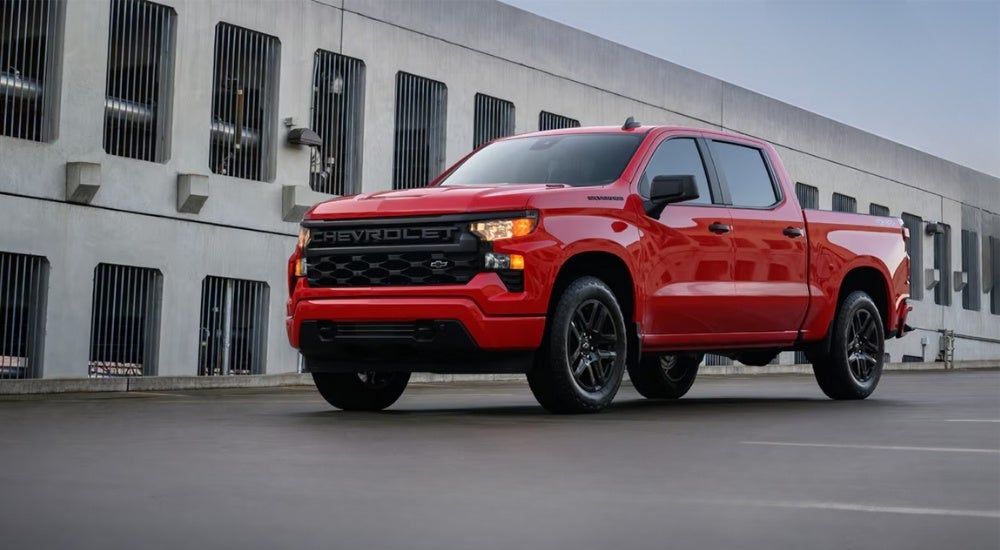 Red 2025 Chevy Silverado 1500 parked in front of a building