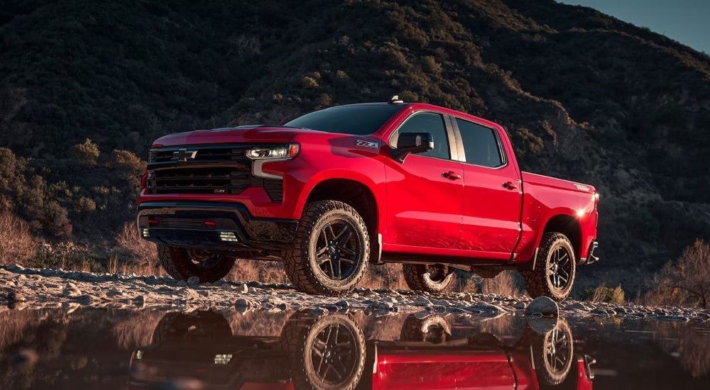 Red 2024 Chevy Silverado 1500 Z71 Trail Boss is parked off-road