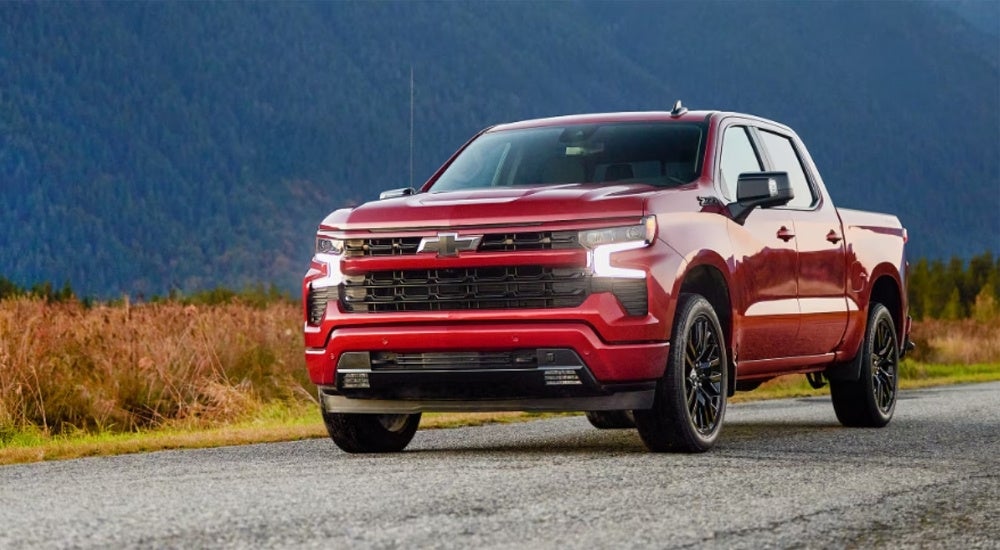 Red 2025 Chevy Silverado 1500 RST parked on a trail