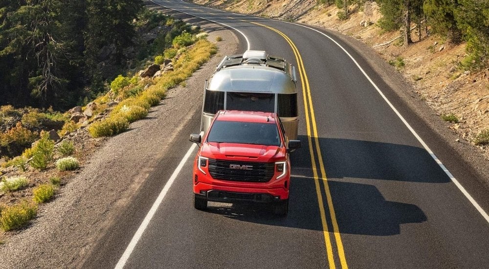 Red 2026 GMC Sierra 1500 Pro towing an Airstream trailer