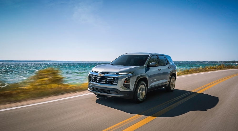 Silver 2026 Chevy Equinox driving to a Chevy dealer near Washington Township