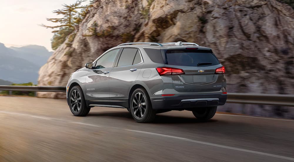 Grey 2024 Chevy Equinox Premier driving on an open road