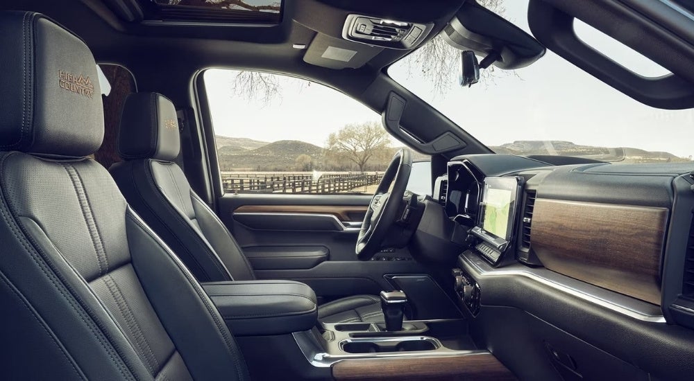 The black and brown interior of a 2023 Chevy Silverado 1500 shows the steering wheel.