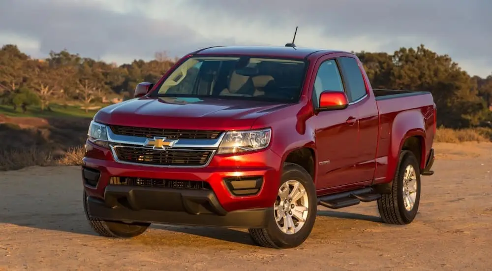 A red 2017 Chevy Colorado is shown parked in a dirt lot.