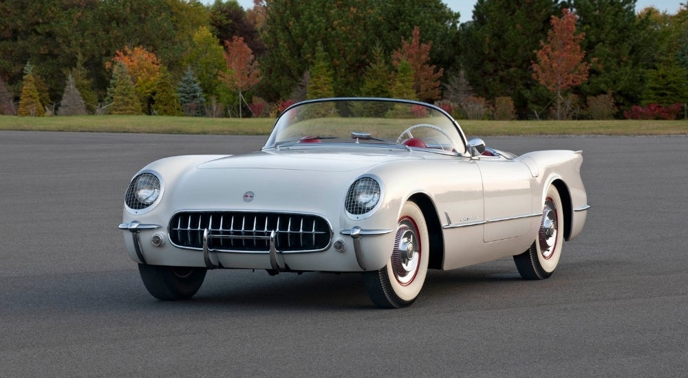 A white 1954 Chevy Corvette convertible parked at a Chevy dealer near Ripley.