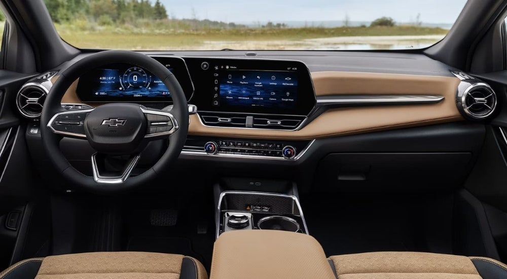 The black and brown interior in a 2025 Chevy Equinox is shown.