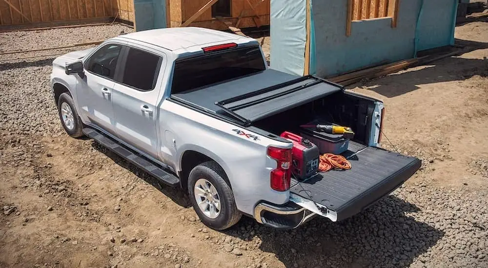 A silver 2022 Chevy Silverado 1500 LTD is parked at a construction site.