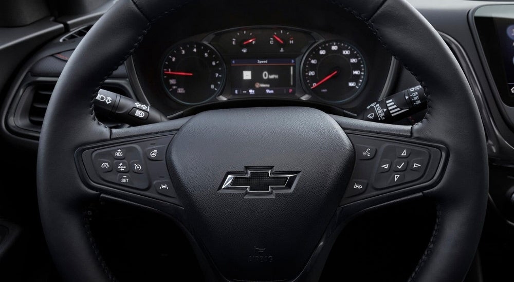 A close up shows the black steering wheel in a 2024 Chevy Equinox.
