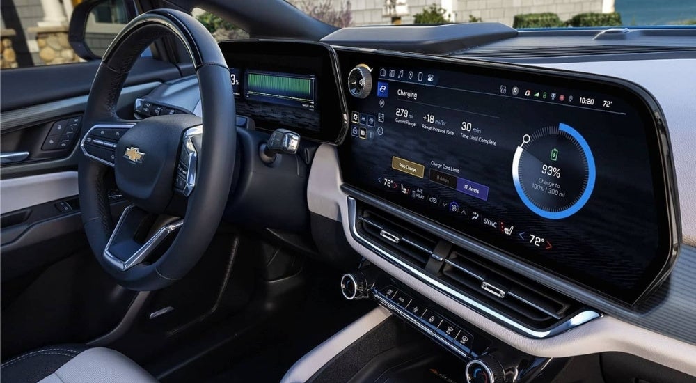 The infotainment screen and battery status is shown in a blue 2024 Chevy Equinox EV.