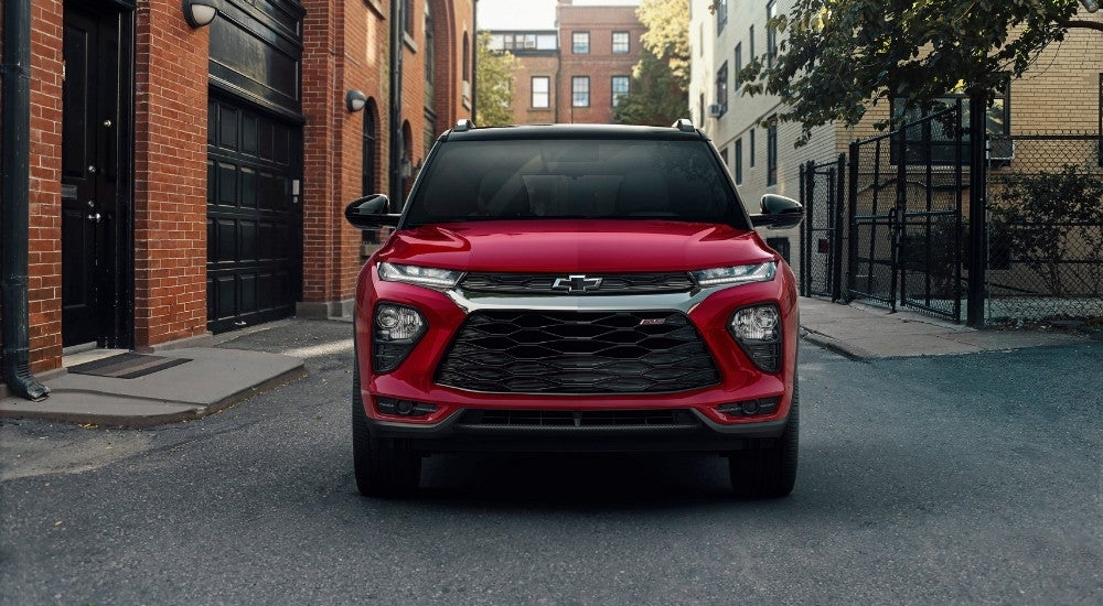 A red 2023 Chevy Trailblazer RS is shown parked in an alleyway.