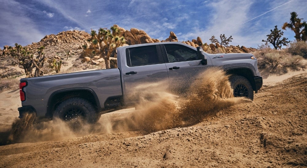 A grey 2024 Chevy Silverado 2500 HD ZR2 is shown from the side while off-road.