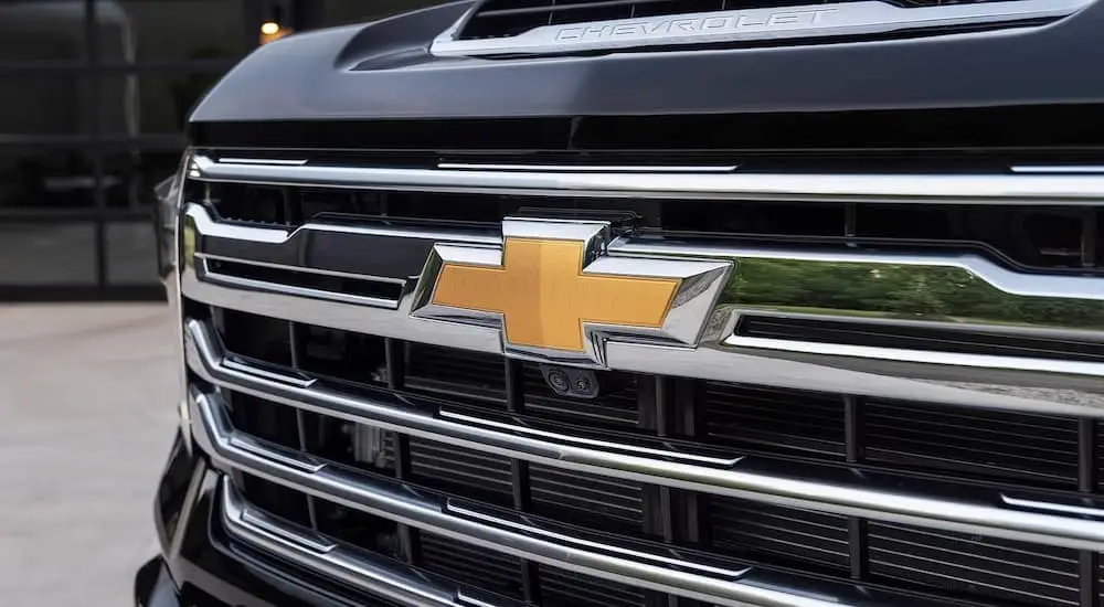 A close up of the grille on a black 2024 Chevy Silverado 2500HD for sale near Albany is shown.