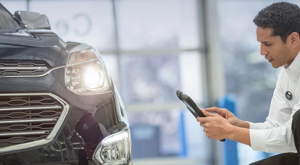 A blue 2016 Chevy Equinox is shown at one of the most popular Chevy dealers in MS.