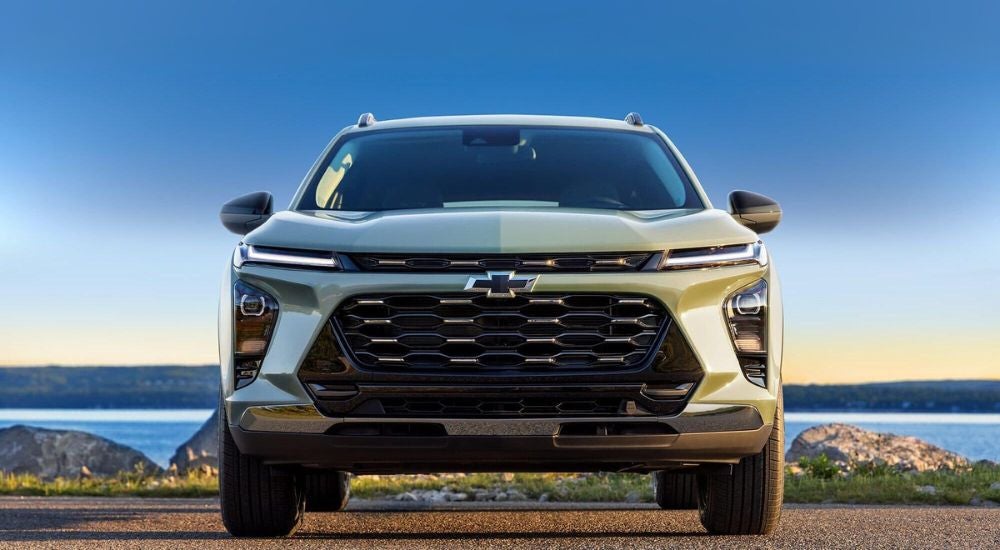 A green 2025 Chevy Trax ACTIV is shown parked on a sunny day.