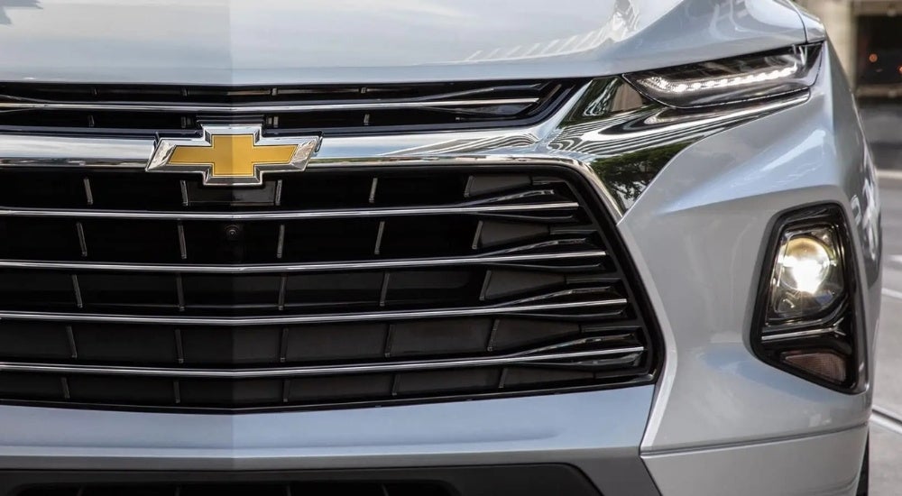 A close-up shows the grille on a silver 2020 Chevy Blazer.
