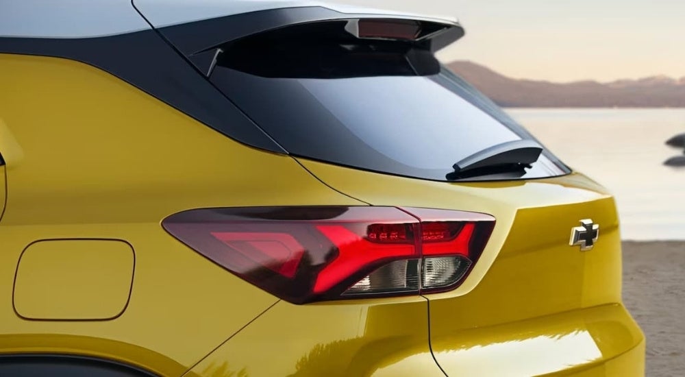 A close-up shows the driver side taillight on a yellow 2023 Chevy Trailblazer for sale.