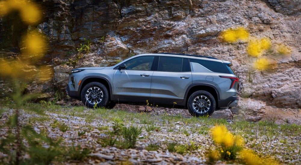 A side angle view of a grey 2024 Chevy Traverse Z71 parked in a flower field.