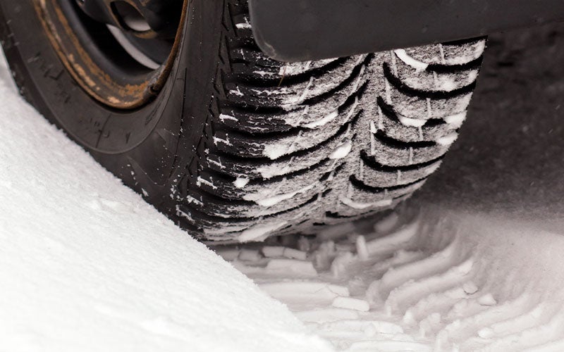 A vehicle tire in the snow - Winter Maintenance