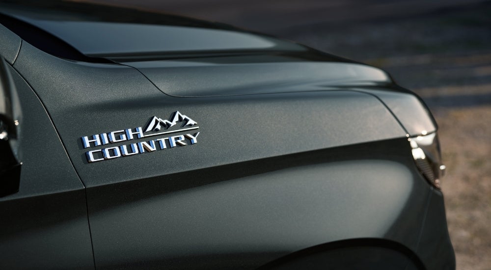 A close-up shows the High Country badge on a black 2021 Chevy Tahoe High Country.