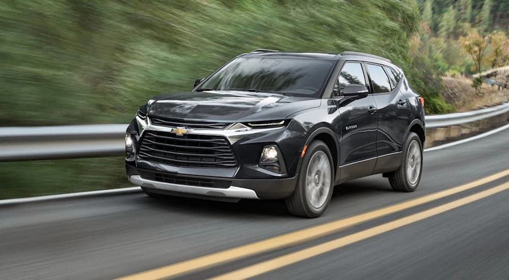 Black 2021 Chevy Blazer driving down a road.
