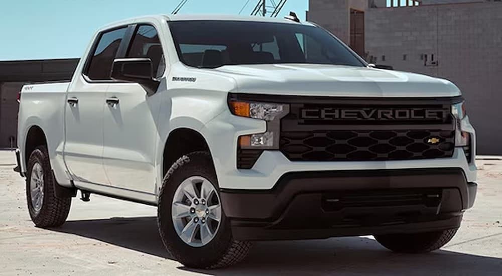A white 2026 Chevy Silverado 1500 parked near buildings.