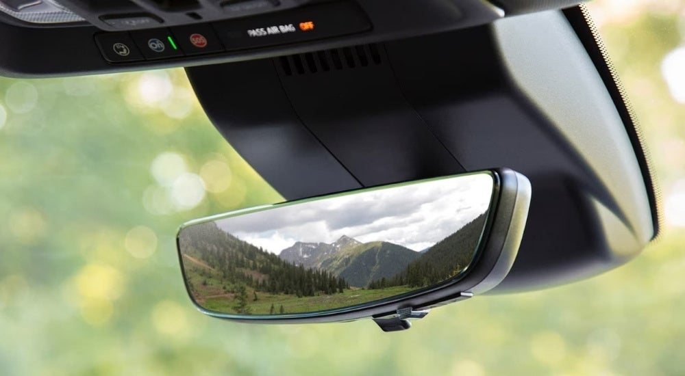 A close-up shows a rear view mirror in a 2024 Chevy Silverado 1500.