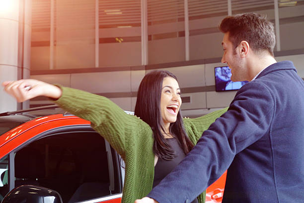 Happy people at a car dealership
