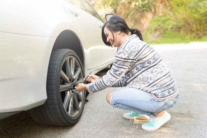 woman changing a tire