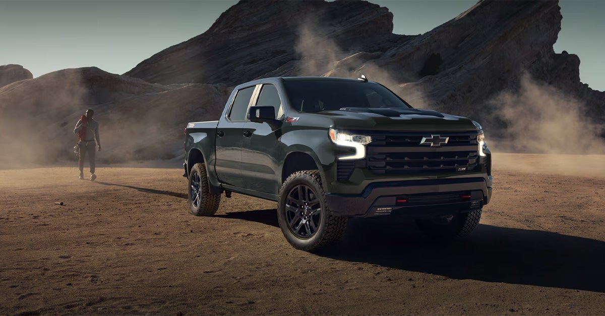 parked in a rugged desert landscape with rocky mountains in the background