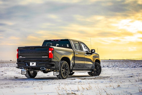 Black Chevy Silverado 1500 on snowy plain at sunrise