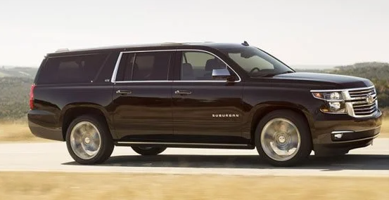 Black Chevrolet Suburban driving on a road