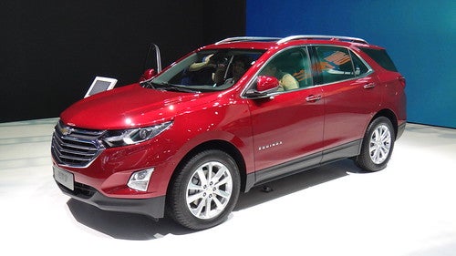 Red 2022 Chevrolet Equinox in a showroom