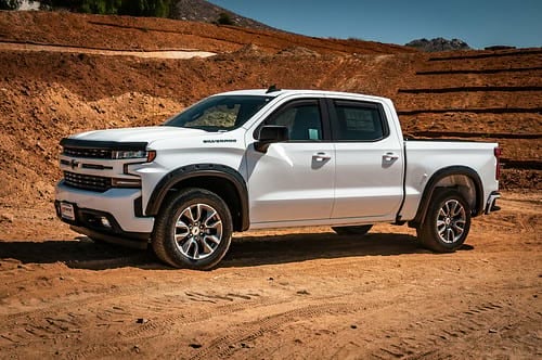 White Chevy Silverado HD at sunny work site