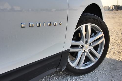 Front right of Chevy Equinox crossover with Equinox logo on it