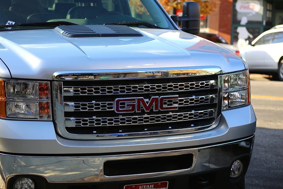 GMC logo on the front grill of a silver truck