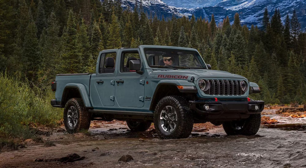 Grey 2026 Jeep Gladiator parked near a shallow creek.