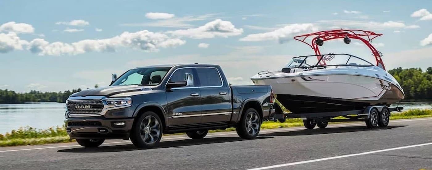Gray 2024 Ram 1500 towing a boat.