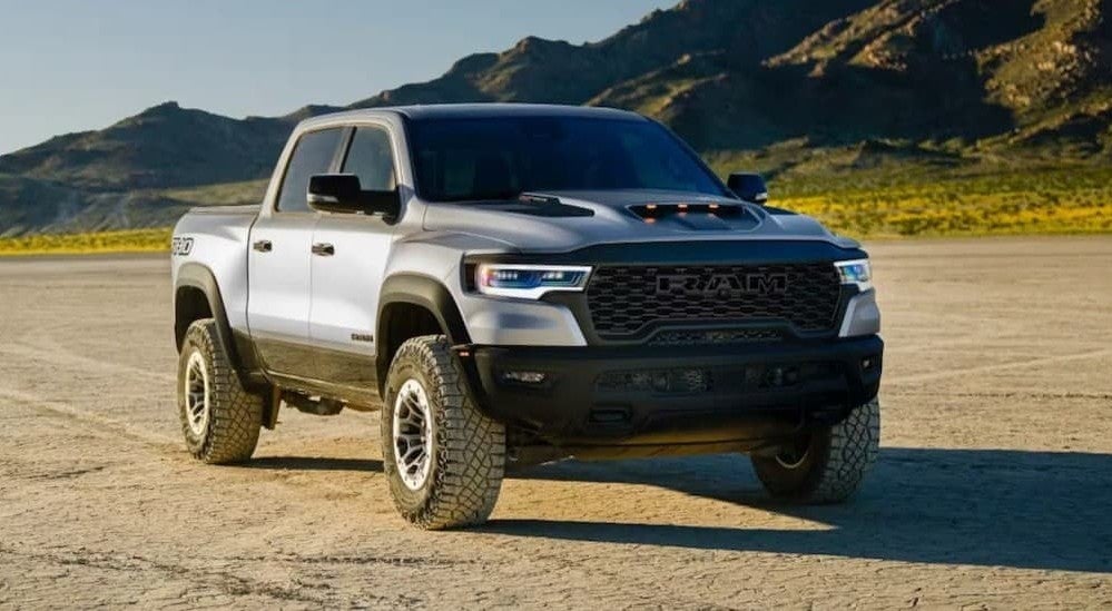 A silver 2027 Ram 1500 RHO parked offroad.