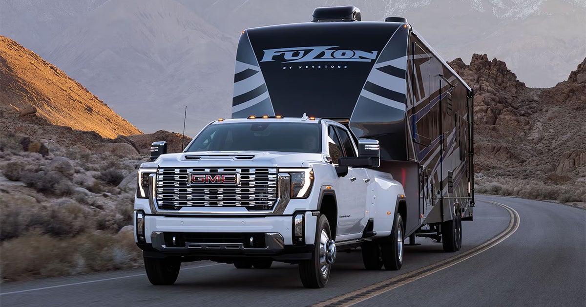 2025 GMC Sierra HD towing capability demonstration with travel trailer highlighting truck performance