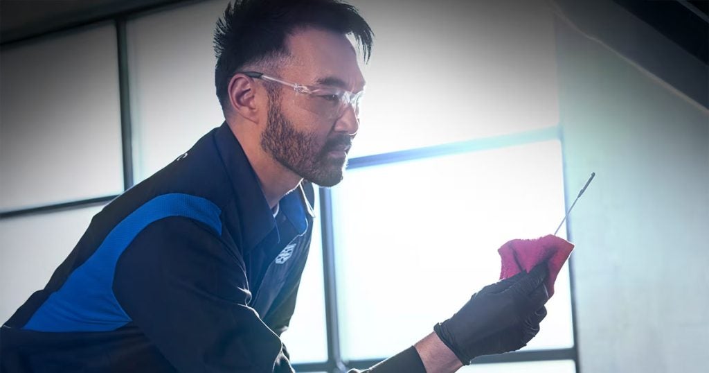 Cadillac service technician changing oil for a Cadillac vehicle.