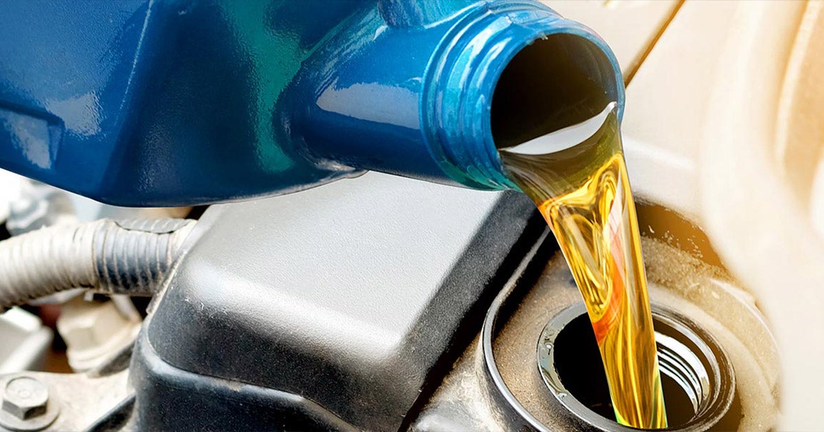 Car oil being poured into engine.